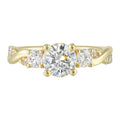 Gorgeous three stone ring features a round solitaire with one smaller diamond on either side. All of this sits a top a criss cross band with playful flow of diamond is a perfect choice. - W0412RN100SM-4YB